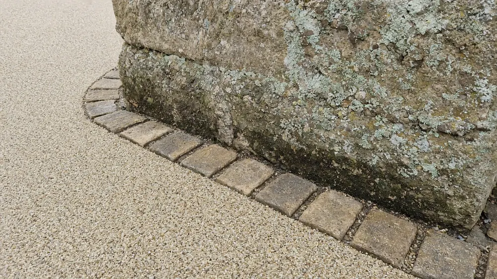 Example image: a sett border beside a resin driveway at an old stone gate pier